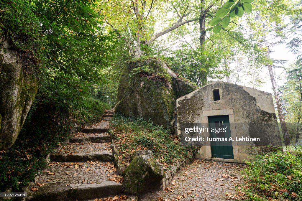 Manueline Chapel, old and small building in lush and verdant natural parkland at the Pena Park surrounding the Pena Palace (Palacio Nacional da Pena) in Sintra, Portugal.