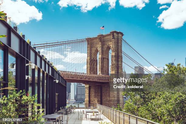 brooklyn bridge against blue sky, as seen from dumbo brooklyn - dumbo new york stock pictures, royalty-free photos & images