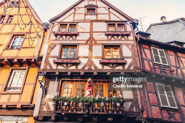 half timbered houses with christmas decorations in obernai, france - obernai stockfoto's en -beelden