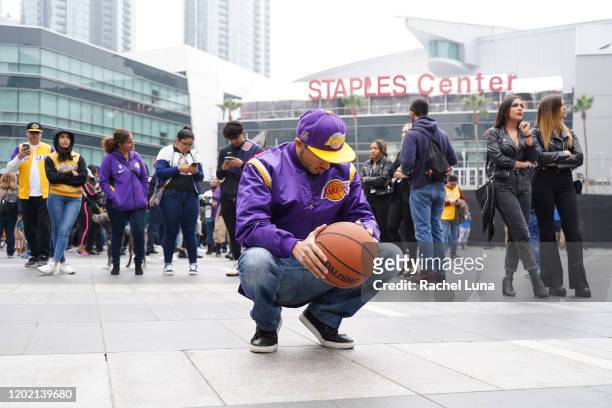 Los Angeles Lakers fan Victor Chavez of Los Angeles, mourns the death of retired NBA star Kobe Bryant outside the Staples Center prior to the 62nd...