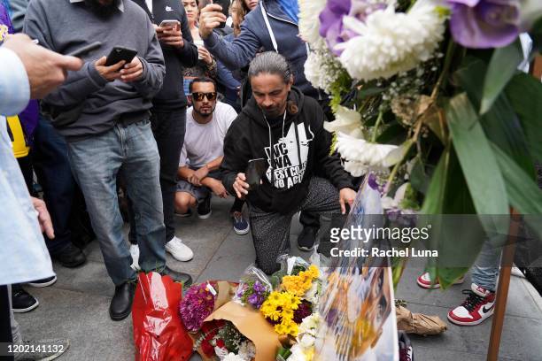 Flowers and tributes are left at a makeshift memorial for former NBA player Kobe Bryant outside the 62nd Annual GRAMMY Awards at STAPLES Center on...