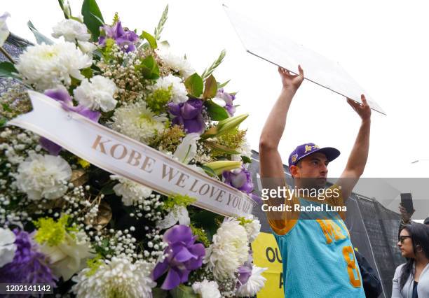 Los Angeles Lakers fan Samuel Krutonog of Los Angeles, mourns the death of retired NBA star Kobe Bryant outside the Staples Center prior to the 62nd...