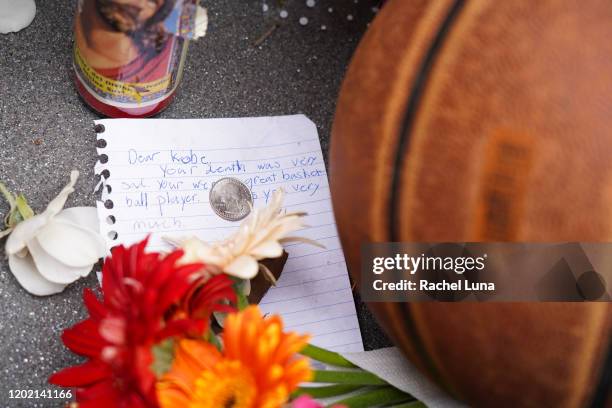 Flowers and tributes are left at a makeshift memorial for former NBA player Kobe Bryant outside the 62nd Annual GRAMMY Awards at STAPLES Center on...