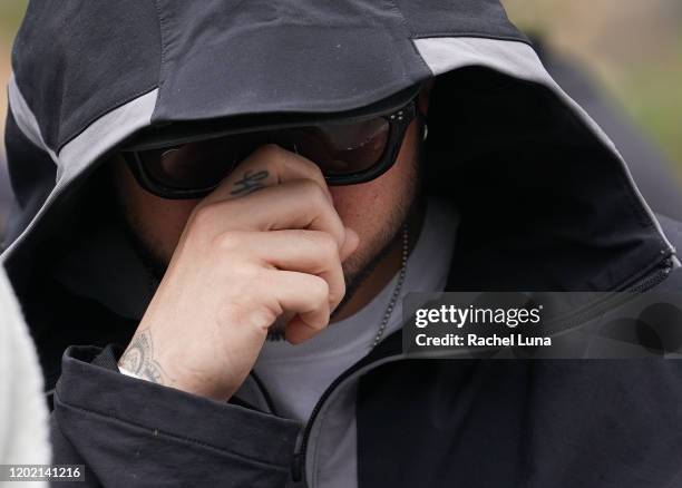 Man mourns the death of retired NBA star Kobe Bryant outside the Staples Center prior to the 62nd Annual Grammy Awards on January 26, 2020 in Los...