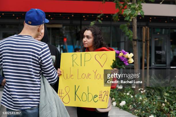 Woman holds a sign to remember retired NBA star Kobe Bryant outside the Staples Center prior to the 62nd Annual Grammy Awards on January 26, 2020 in...