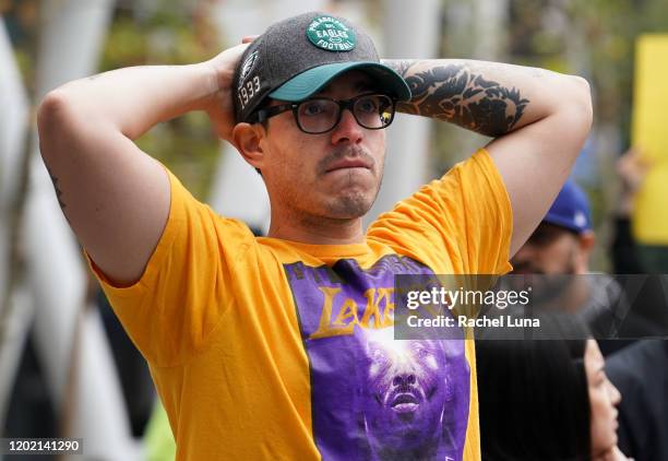 Los Angeles Lakers fan mourns the death of retired NBA star Kobe Bryant outside the Staples Center prior to the 62nd Annual Grammy Awards on January...