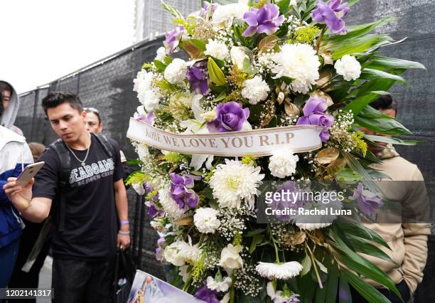 Flowers and tributes are left at a makeshift memorial for former NBA player Kobe Bryant outside the 62nd Annual GRAMMY Awards at STAPLES Center on...