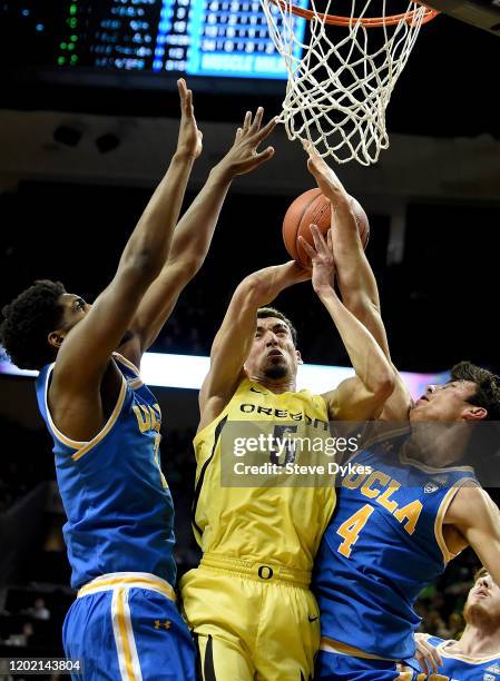 Chris Duarte of the Oregon Ducks drives tot the basket on Cody Riley and Jaime Jaquez Jr. #4 of the UCLA Bruins during the first half at Matthew...