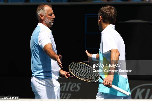 Thomas Muster of Austria and Mats Wilander of Sweden high five in their Men's Legends Doubles match against Pat Cash and Mark Woodforde of Australia...