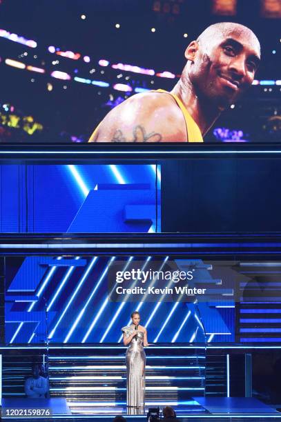 An image of the late Kobe Bryant is projected onto a screen while host Alicia Keys speaks onstage during the 62nd Annual GRAMMY Awards at STAPLES...