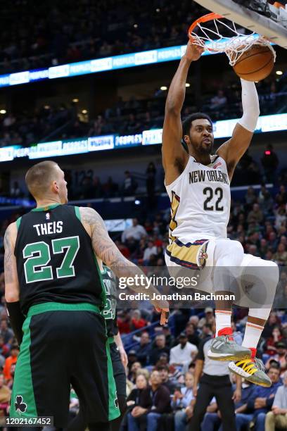 Derrick Favors of the New Orleans Pelicans dunks as Daniel Theis of the Boston Celtics defends during the second half at the Smoothie King Center on...