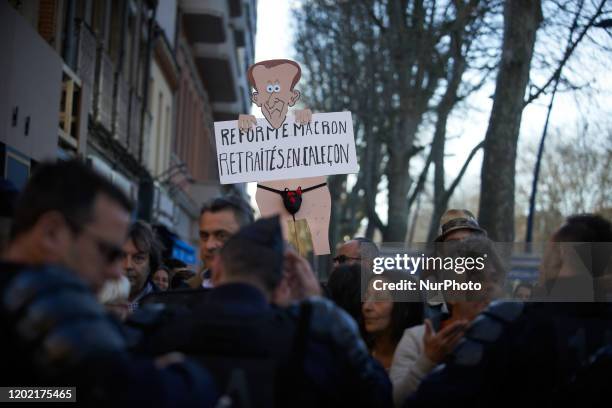 Riotpolicemen block people at the end of the protest. A placard reads 'Macron's reform, retired people in shorts'. Thousands of protesters...