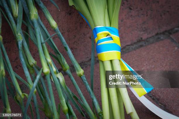 Flowers wrapped in ribbons with the colors of the Ukrainian flag are seen in Kyiv, Ukraine on February 20, 2020. Six years ago over a hundred...