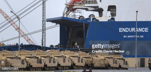 Military personnel unload tanks from the U.S. 2nd Brigade Combat Team, 3rd Infantry Division, from a ship at Bremerhaven port on February 21, 2020 in...
