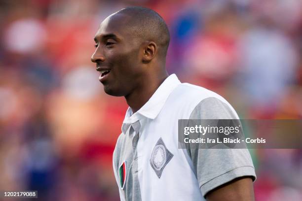 Los Angeles Lakers legend Kobe Bryant walk's the pitch at halftime session with him kicking some soccer balls during the Herbalife World Football...