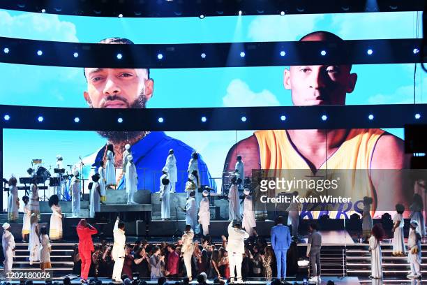 Images for the late Nipsey Hussle and Kobe Bryant are projected onto a screen while YG, John Legend, Kirk Franklin, DJ Khaled, Meek Mill, and Roddy...