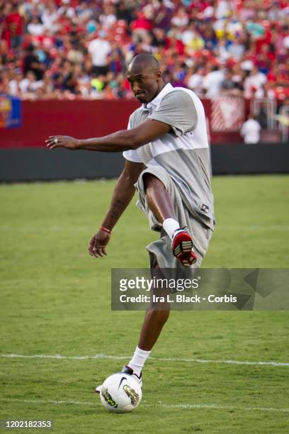 Los Angeles Lakers legend Kobe Bryant watches his shot on goal the during the halftime session with him kicking some soccer balls during the...