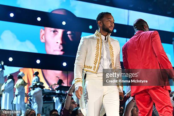 Images for the late Nipsey Hussle and Kobe Bryant are projected onto a screen while John Legend and YG perform onstage during the 62nd Annual GRAMMY...