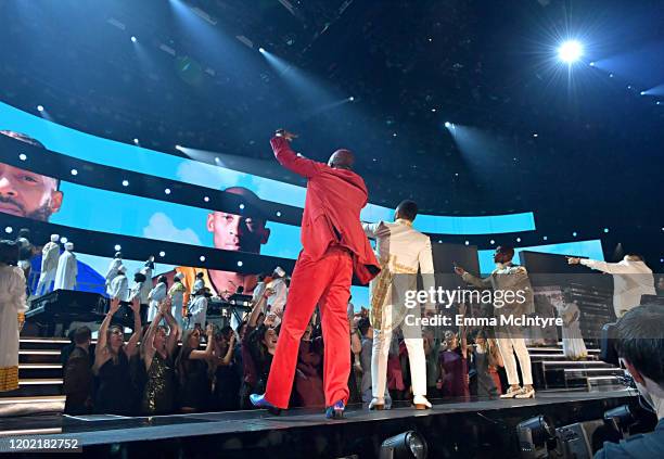 Images for the late Nipsey Hussle and Kobe Bryant are projected onto a screen while YG, John Legend, Kirk Franklin, DJ Khaled, Meek Mill, and Roddy...