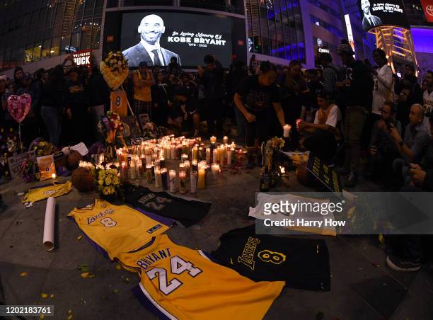 Fans gather at LA Live to pay tribute to Kobe Bryant who died earlier in a helicopter crash on January 26, 2020 in Los Angeles, California.