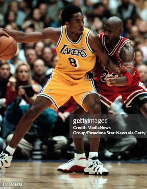 Kobe Bryant of the Lakers goes up against Michael Jordan of the Bulls in the lakers Sunday afternoon win.
