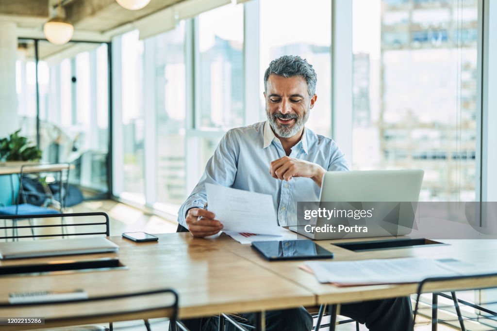 Confident businessman working at coworking space