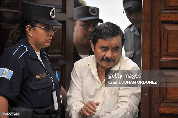 Reyes Collin Gualip, one of the four military men accused of the murder of 252 farmers in 1982, arrive at court during their trial, in Guatemala...