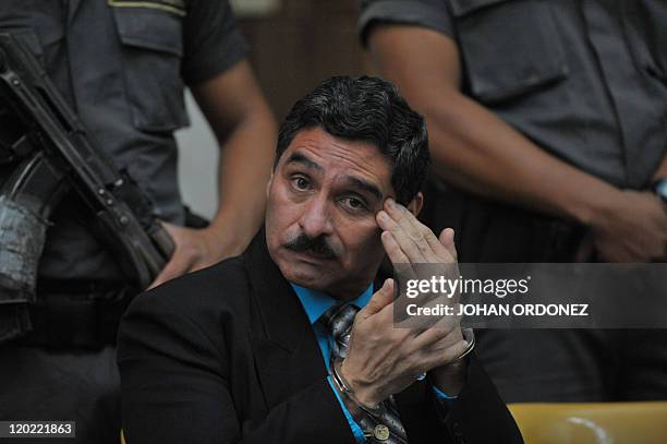 Carlos Antonio Carias Lopez , one of four military men accused of the murder of 252 farmers in 1982, gestures during their trial, in Guatemala City,...