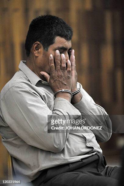 Manuel Pop Sun, one of four military men accused of the murder of 252 farmers in 1982, gestures during their trial, in Guatemala City, on August 1,...