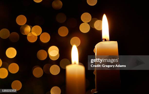 candles burning in front of out of focus lights - candel stockfoto's en -beelden