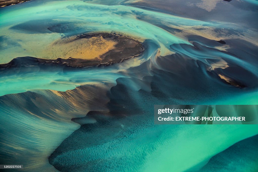 Beautiful emerald-colored glacial rivers of Iceland, taken from a helicopter