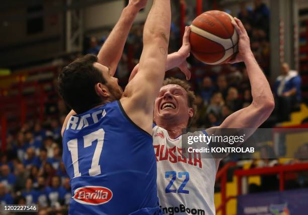 Russia's shooting guard Dmitrii Kulagin shoots as fighting with Italy's small forward Giampaolo Ricci during the FIBA Eurobasket 2021 Group B...