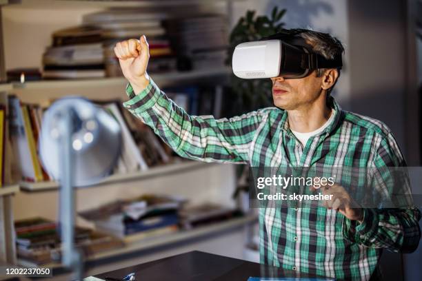 businessman having fun while using vr headset in the office. - virtual library stock pictures, royalty-free photos & images