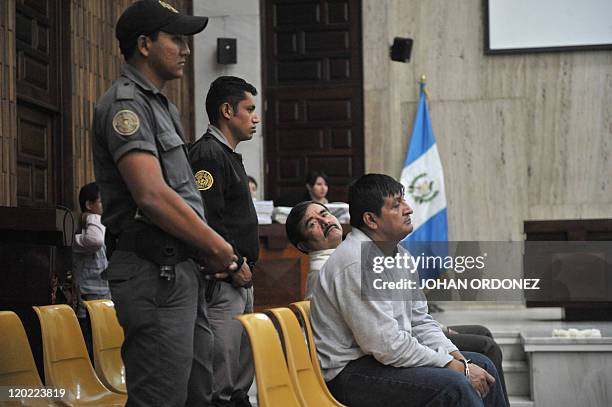Reyes Collin Gualip and Daniel Martinez Mendez , two of the four military men accused of the murder of 252 farmers in 1982, gestures during their...