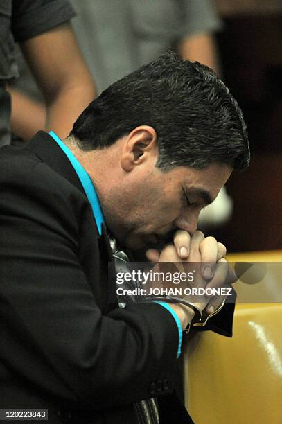 Carlos Antonio Carias Lopez, one of four military men accused of the murder of 252 farmers in 1982, gestures during their trial, in Guatemala City,...