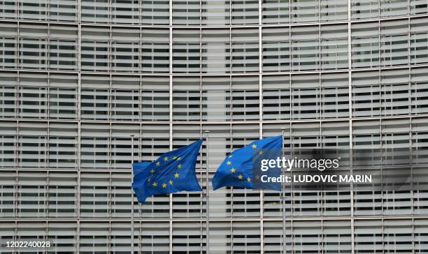 European Union flags flutter in the breeze during the second day of a special European Council summit in Brussels on February 21 held to discuss the...