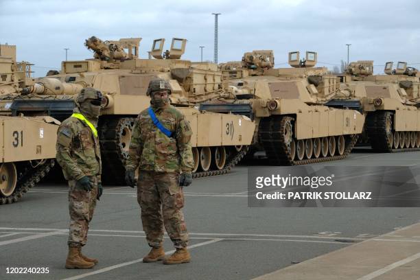 Military personnel unload M1 Abrams Fighting tanks of the 2nd Brigade Combat Team, 3rd Infantry Division, as US military equipment arrives to the...