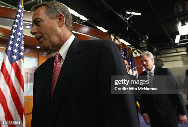 Speaker of the House John Boehner leaves a news conference on the debt limit impasse with Republican Whip Kevin McCarthy and House Majority Leader...