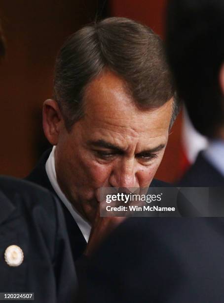 Speaker of the House John Boehner listens during a news conference on the debt limit impasse as House Majority Leader Eric Cantor speaks at the U.S....