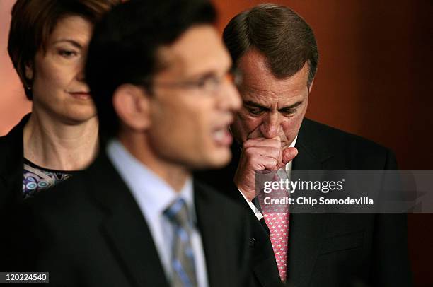 Speaker of the House John Boehner listens to Majority Leader Eric Cantor during a news conference at the U.S. Capitol August 1, 2011 in Washington,...