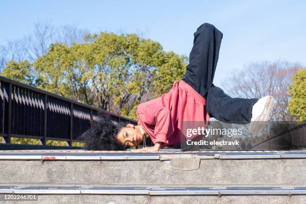 young dancer practicing outside - breakdancing stock pictures, royalty-free photos & images