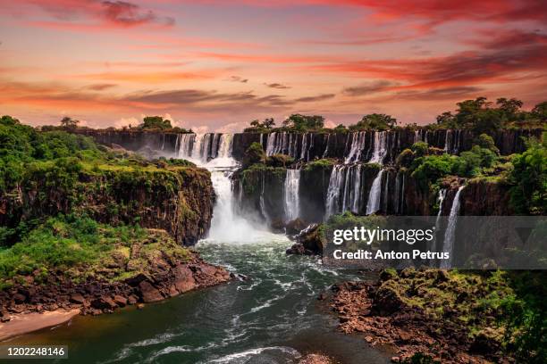 beautiful sunset at iguazu falls.  one of the new seven wonders of nature. traveling south america - brazil rainforest stockfoto's en -beelden