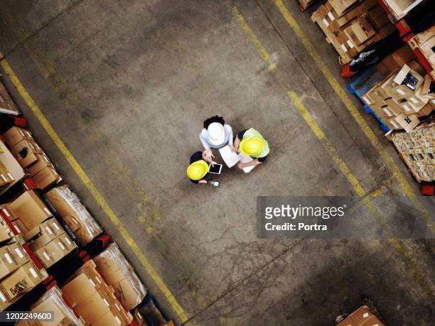 supervisor discussing with employees at warehouse - plant from above stock pictures, royalty-free photos & images