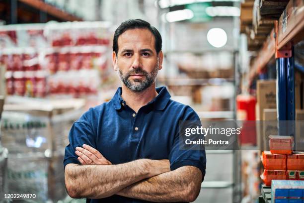 portrait of confident manual worker at warehouse - hardware shop stock pictures, royalty-free photos & images