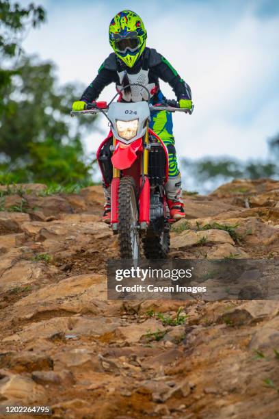 woman on off road bike riding down a rough trail - google ventures stock pictures, royalty-free photos & images