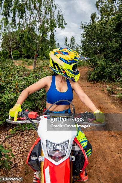 woman posing on her dirt bike in a forrest - google ventures stock pictures, royalty-free photos & images