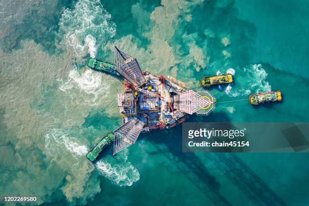 supply boat are towing oil drilling rig for transportation to oil field platform for oil and gas business. - oil industry fotografías e imágenes de stock