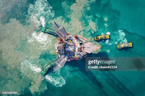 supply boat are towing oil drilling rig for transportation to oil field platform for oil and gas business. - naturföreteelse bildbanksfoton och bilder