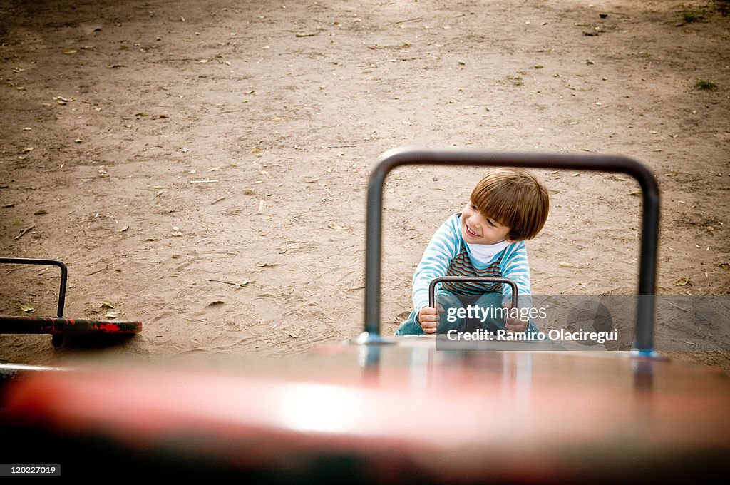 Boy sitting on seesaw