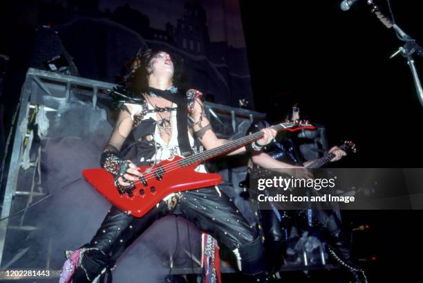 Mötley Crüe co-founder and bass player Nikki Sixx and lead singer Vince Neil perform onstage at the Joe Louis Arena during the Theater of Pain tour,...